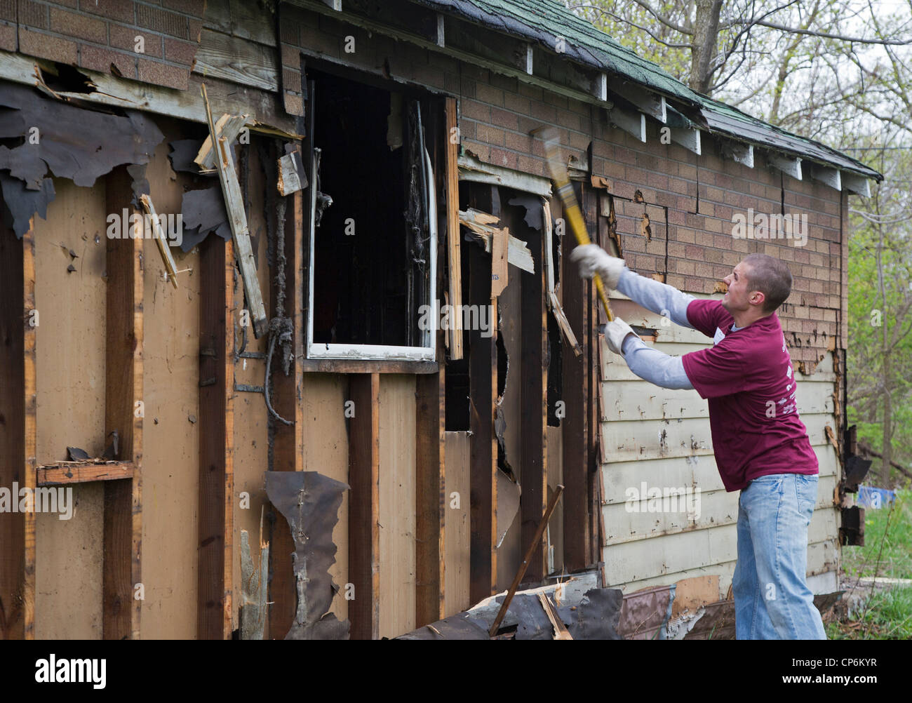 Student volunteers from the University of Michigan demolish one of the thousands of abandoned houses in the city Stock Photo
