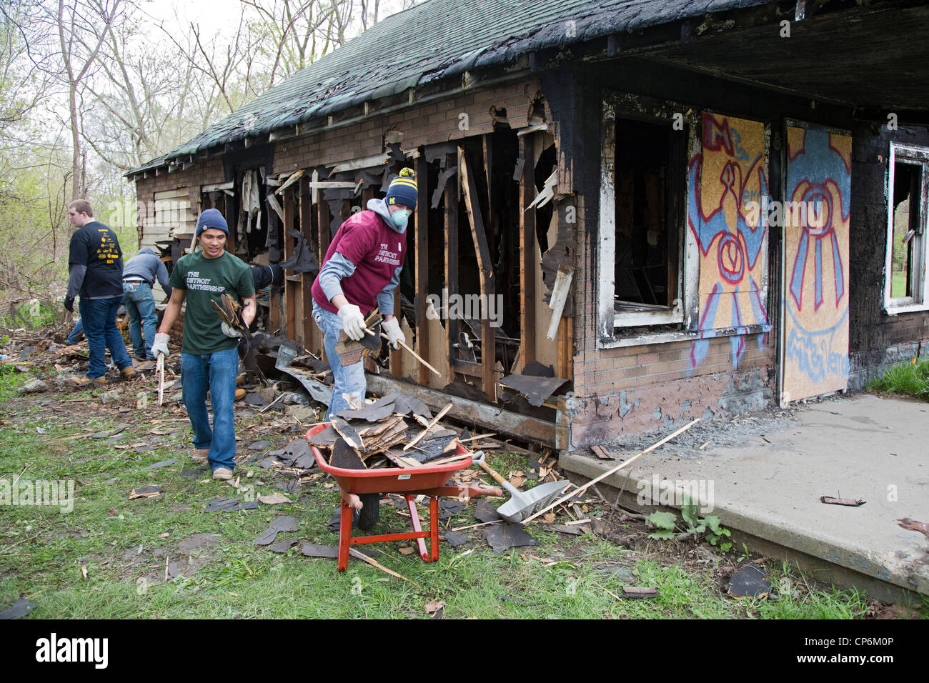Student volunteers from the University of Michigan demolish one of the thousands of abandoned houses in the city Stock Photo