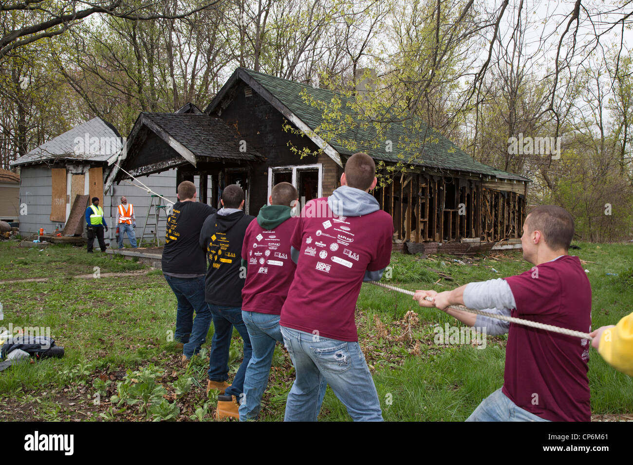 Student volunteers from the University of Michigan demolish one of the thousands of abandoned houses in the city Stock Photo