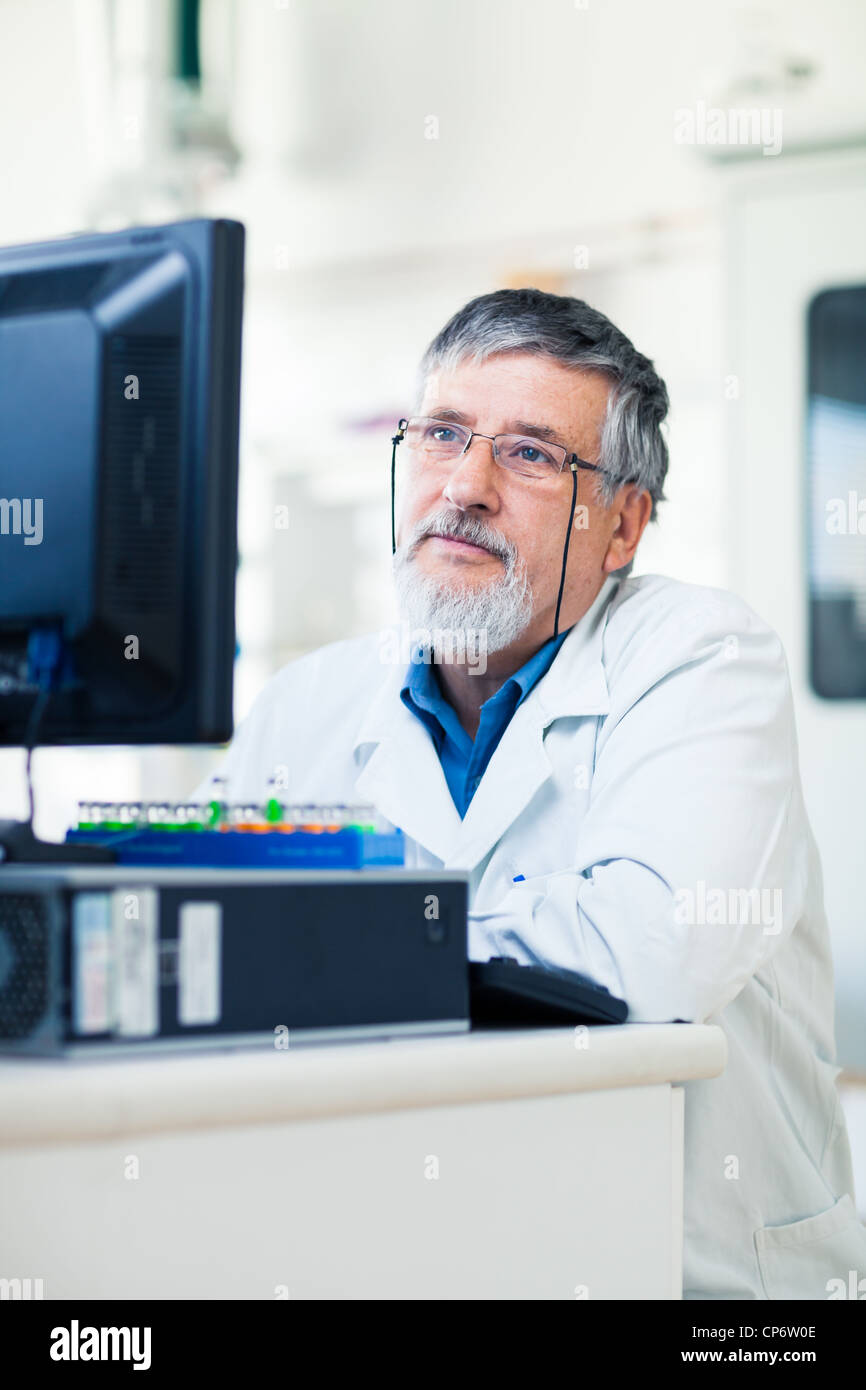 Senior researcher using a computer in the lab while working on an ...