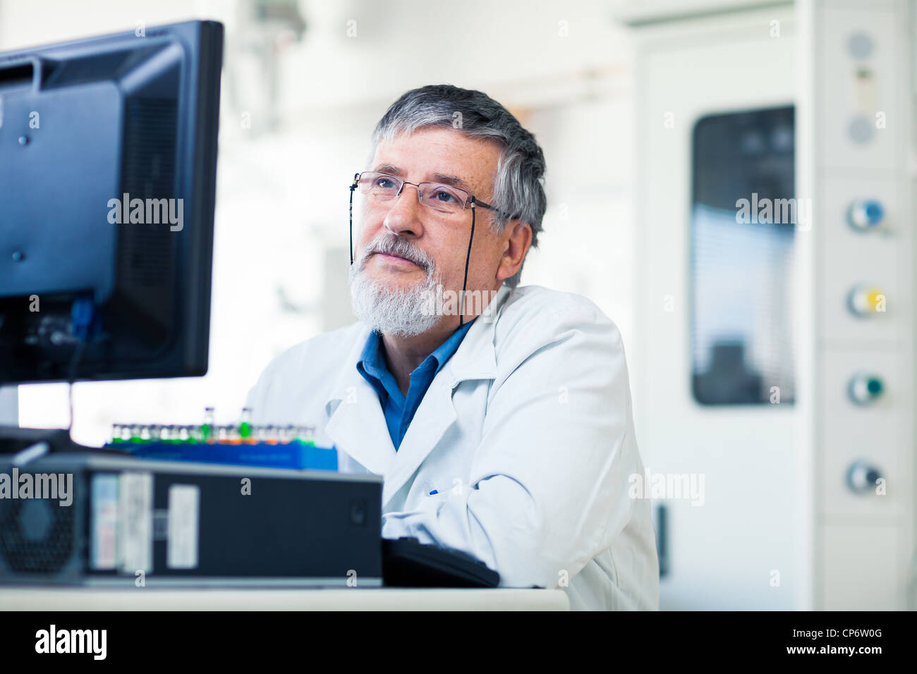 Senior researcher using a computer in the lab while working on an ...