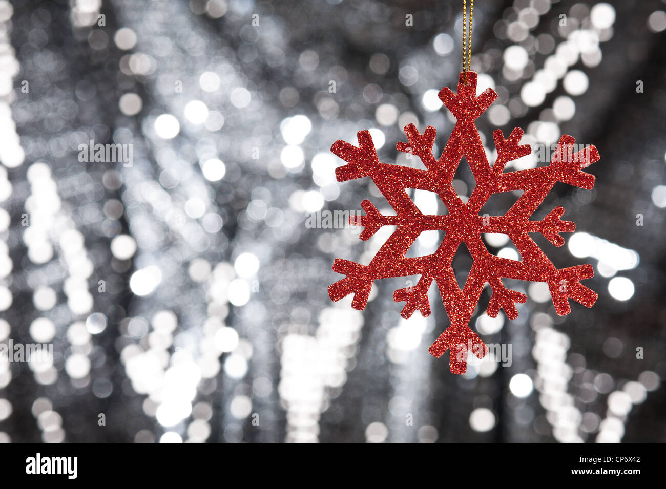 Red snow flake on a silver glitter background for Christmas Stock Photo ...