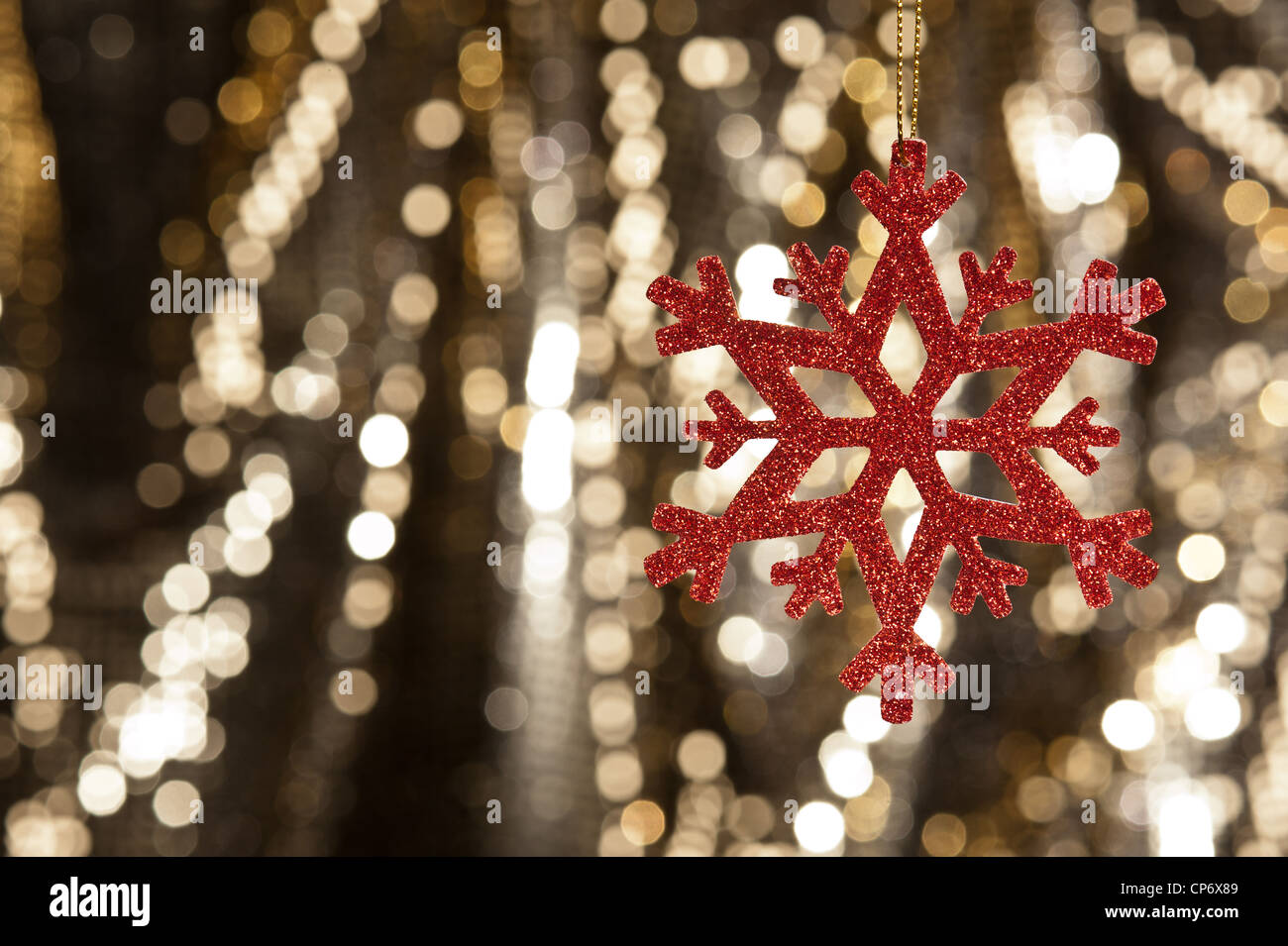 Red snow flake on a gold glitter background for Christmas Stock Photo ...