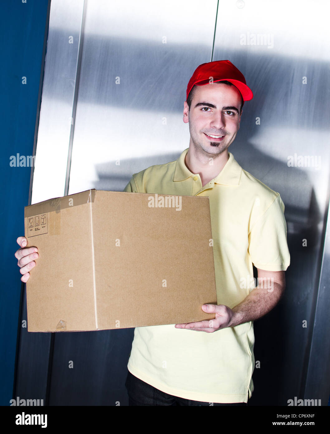 Postman is making a delivery near office elevator Stock Photo Alamy