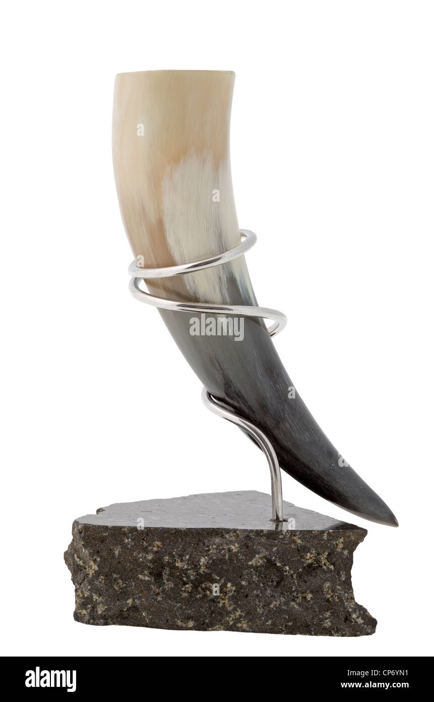 A drinking horn made from a sheep's horn in a silver stand Stock Photo