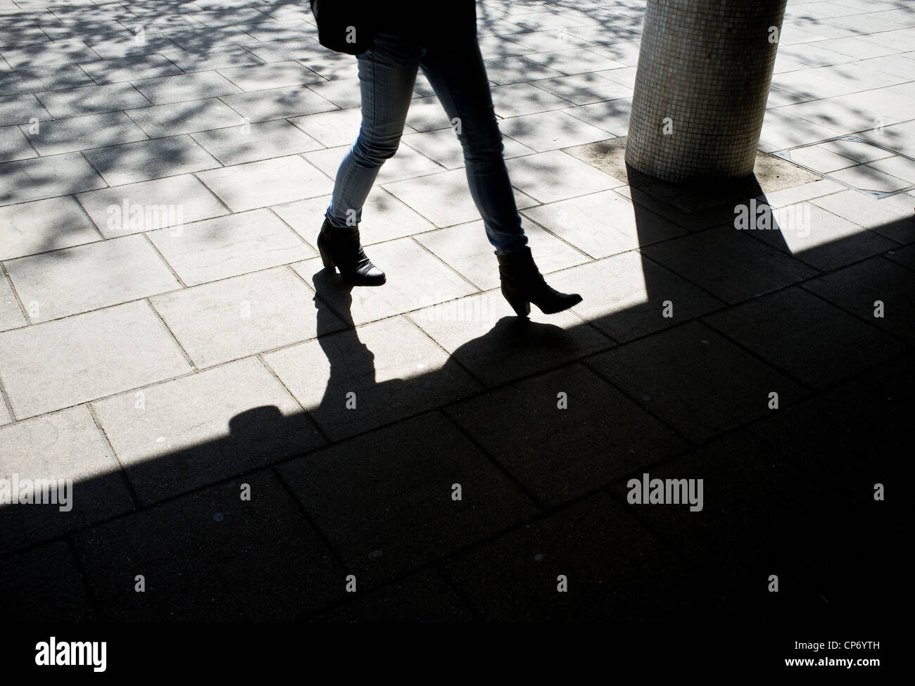 The silhouette of a woman walking into shadows Stock Photo - Alamy