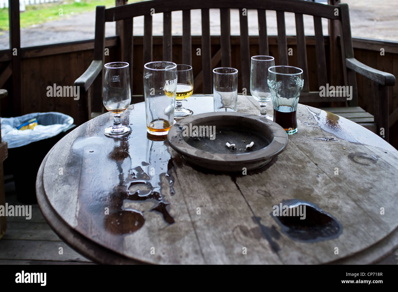 A pub table with ashtray and empty glasses Stock Photo Alamy