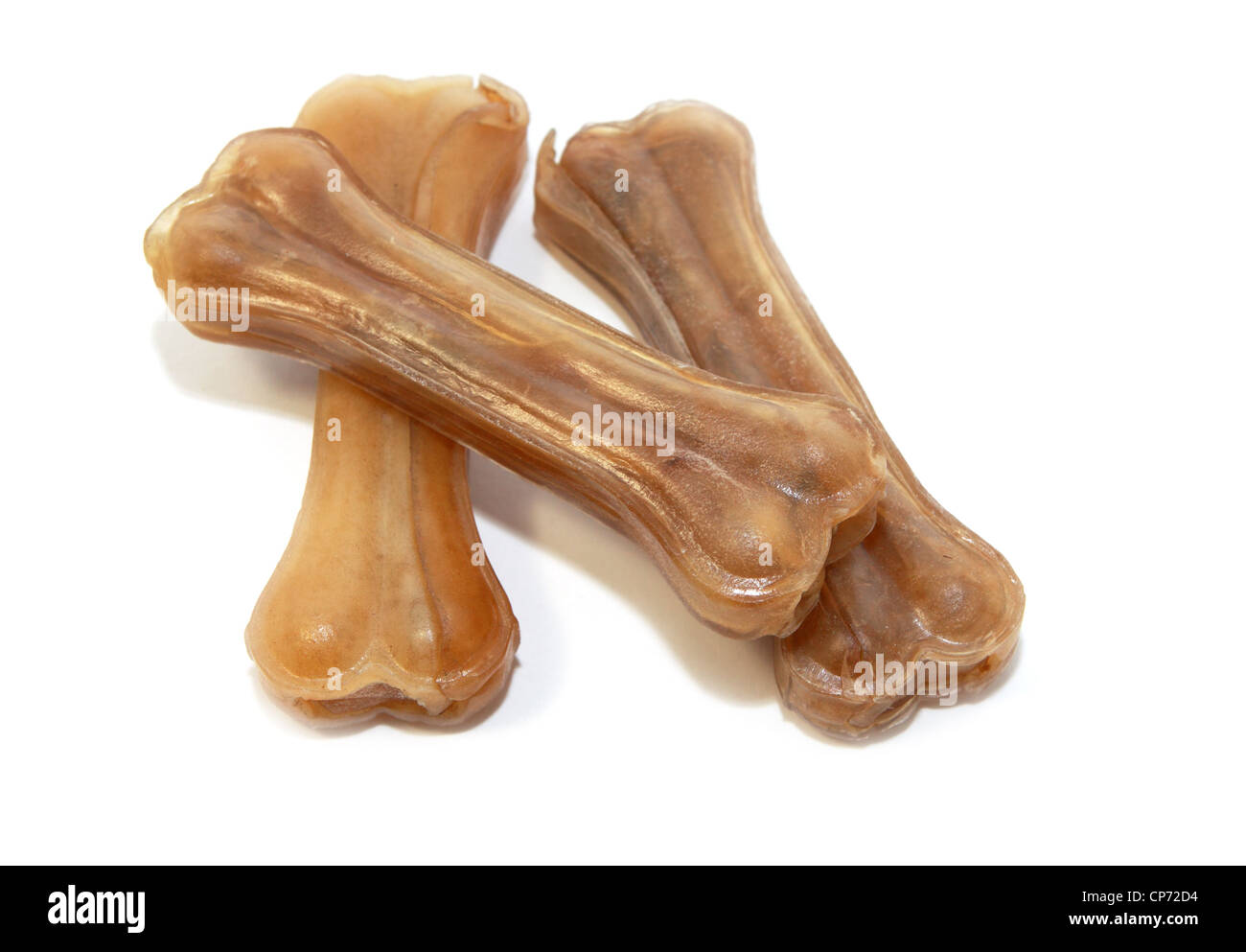 chewing dried bones for dogs on white background Stock Photo Alamy