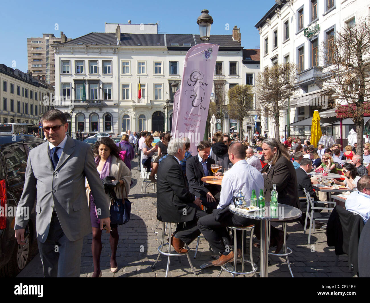 Many people enjoying the sun during their lunch break on the Place du Luxembourg in Brussels, Belgium Stock Photo