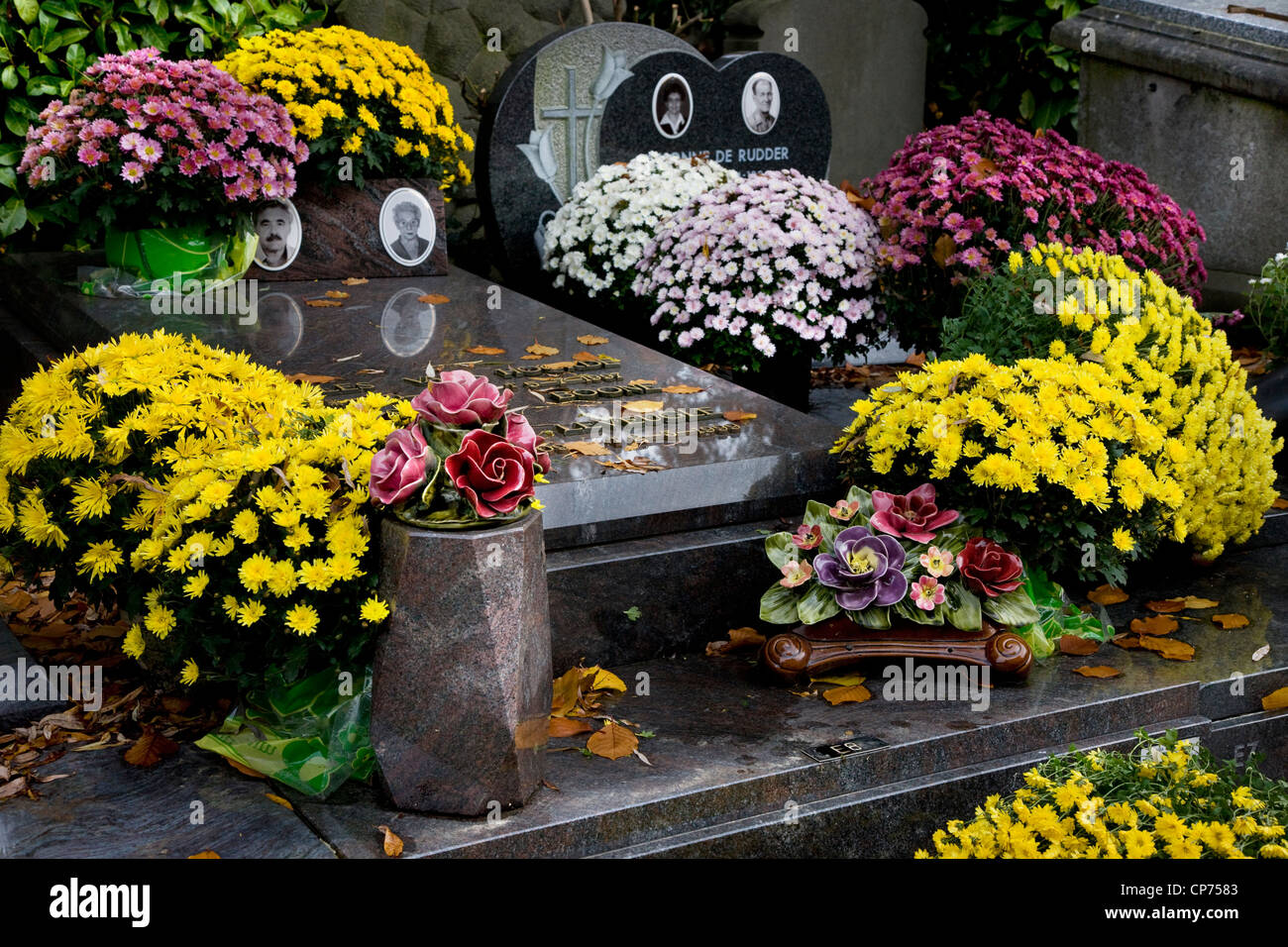 Flowers on graves in autumn at the Campo Santo cemetery in Sint-Amandsberg near Ghent, Belgium Stock Photo