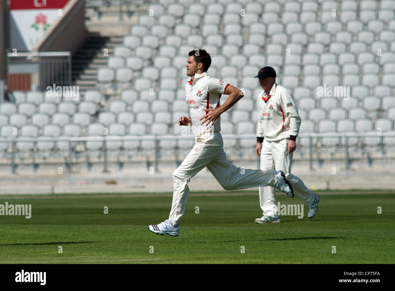 jimmy anderson runs in to bowl at old trafford cricket ground Stock Photo