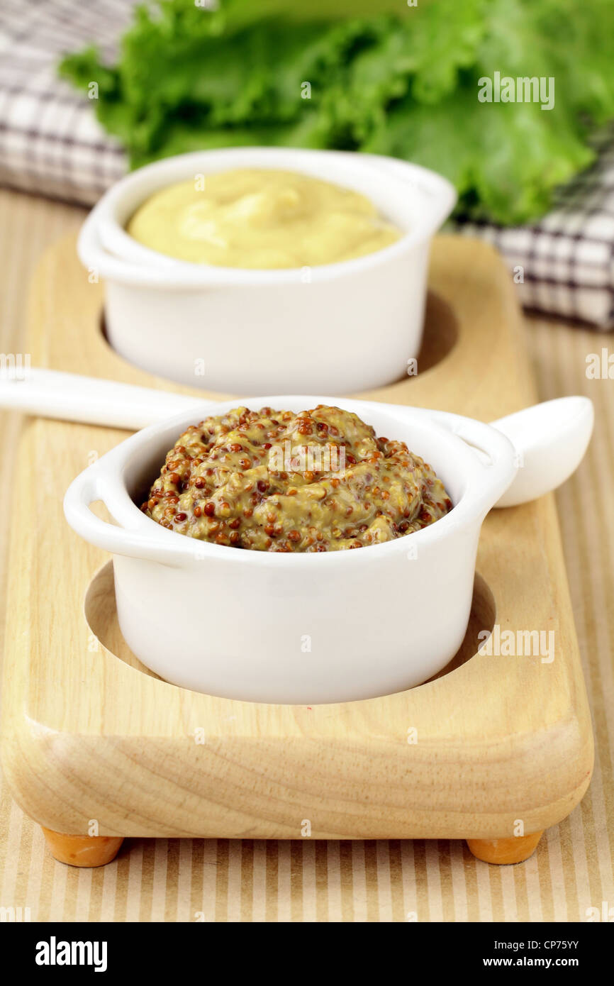 French mustard sauce in white gravy boat Stock Photo