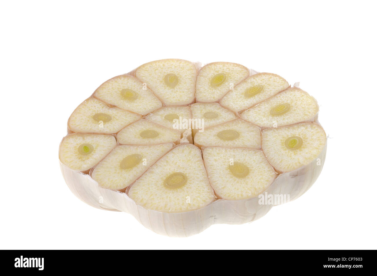 Garlic cut into half with the separate cloves showing isolated on