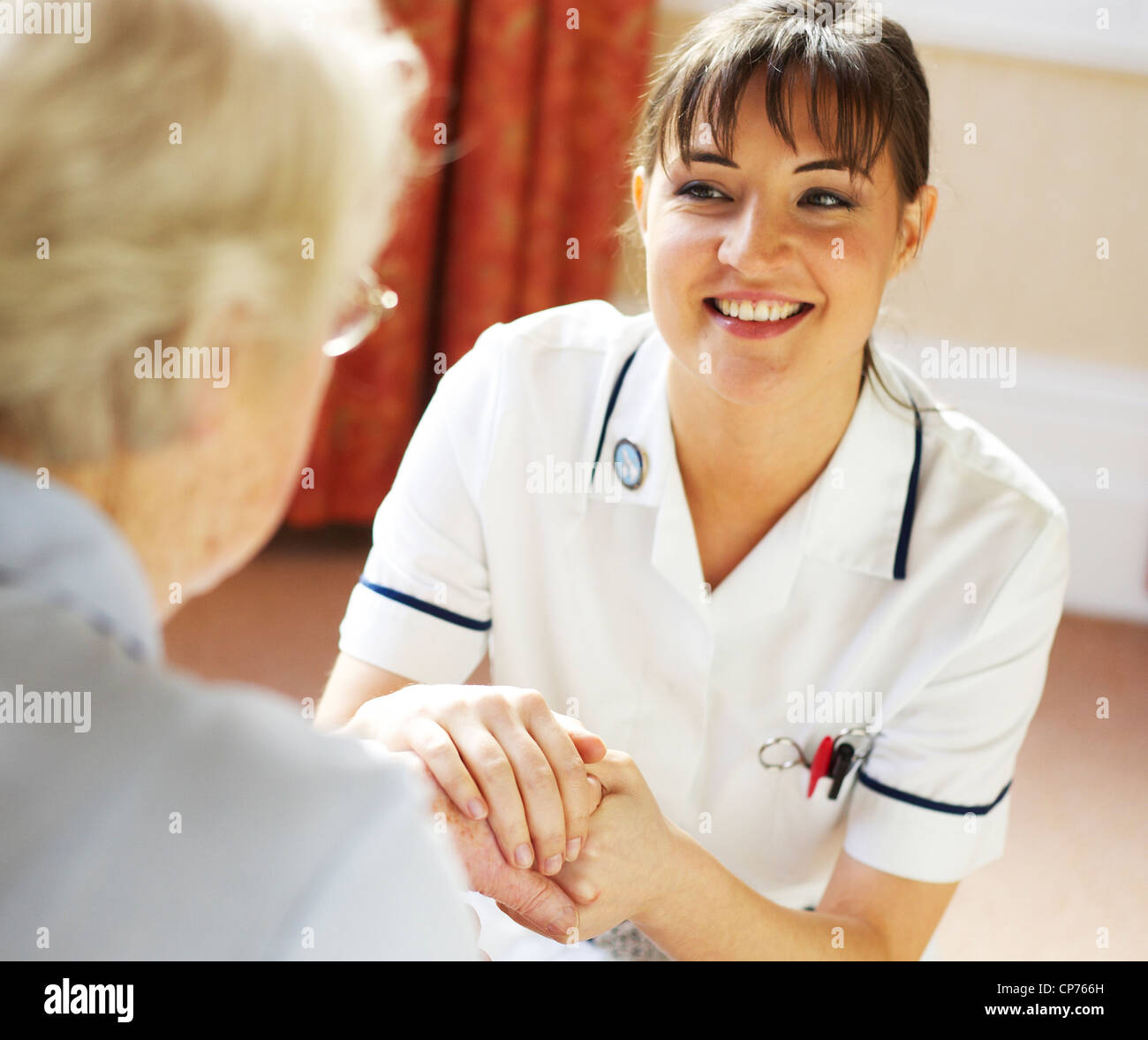 District nurse giving advice on home visit Stock Photo Alamy