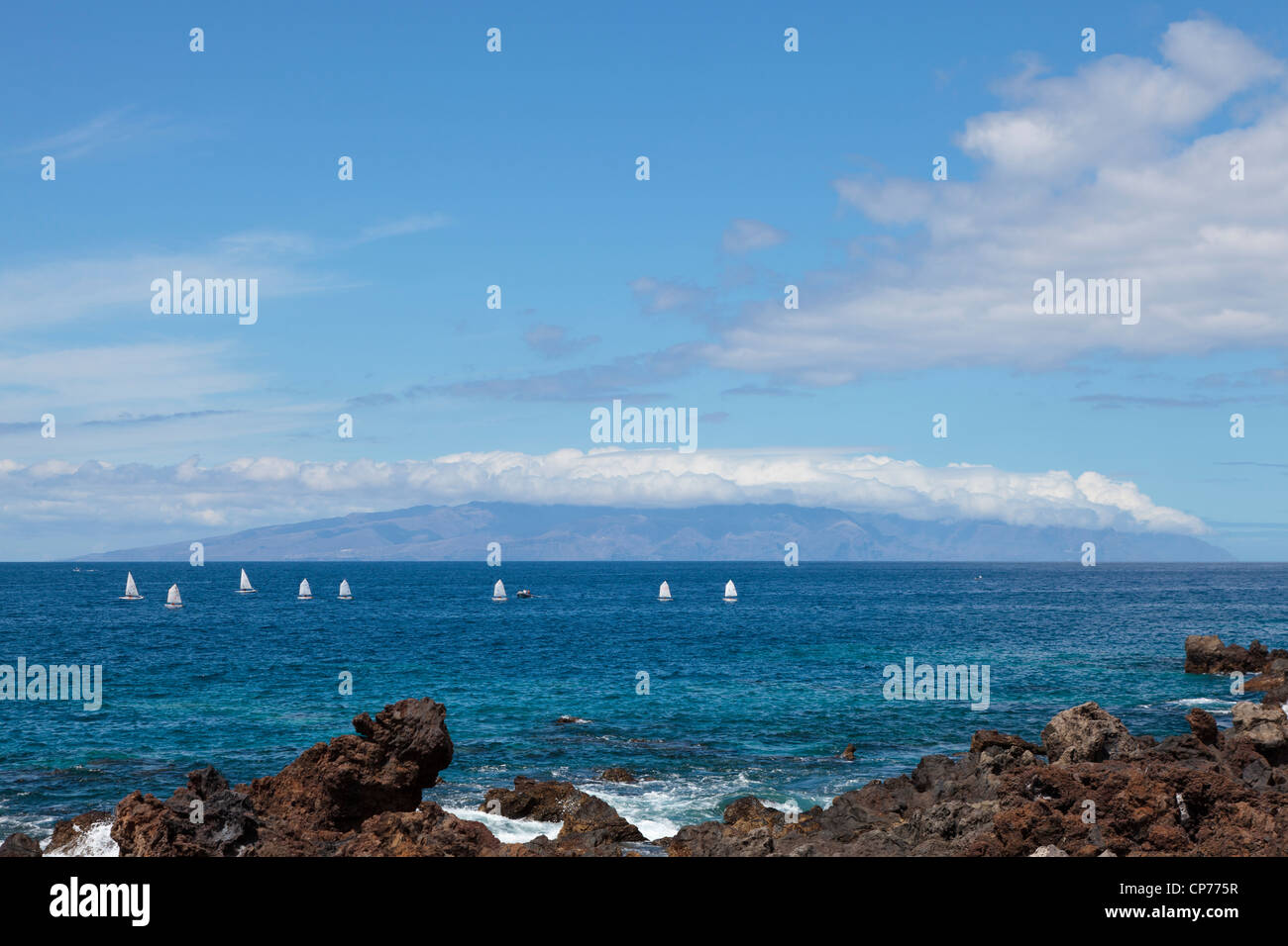 Dinghy sailing off the west coast of Tenerife, La Gomera in the background, Canary islands