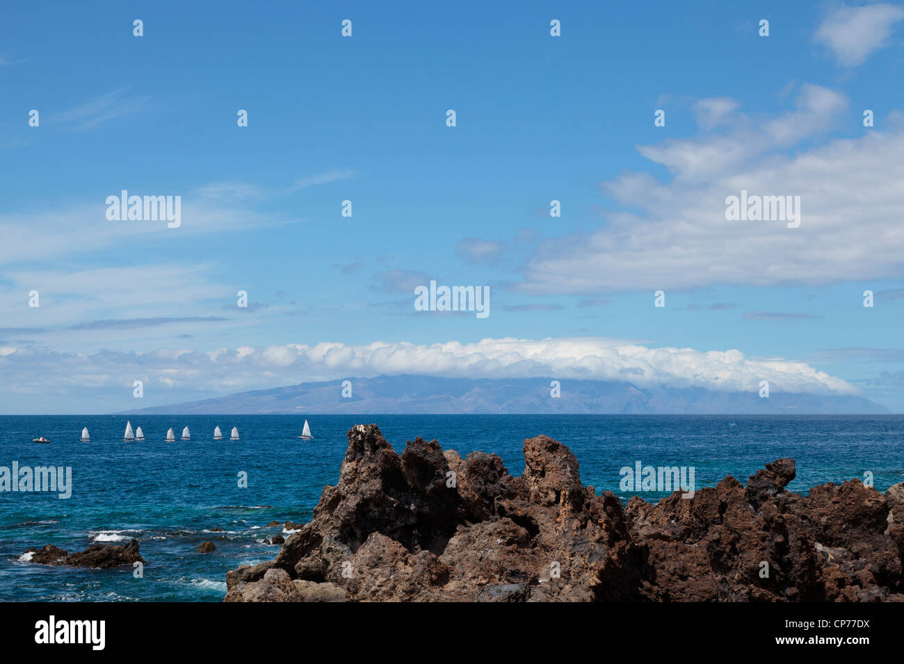 Dinghy sailing off the west coast of Tenerife, La Gomera in the background, Canary islands
