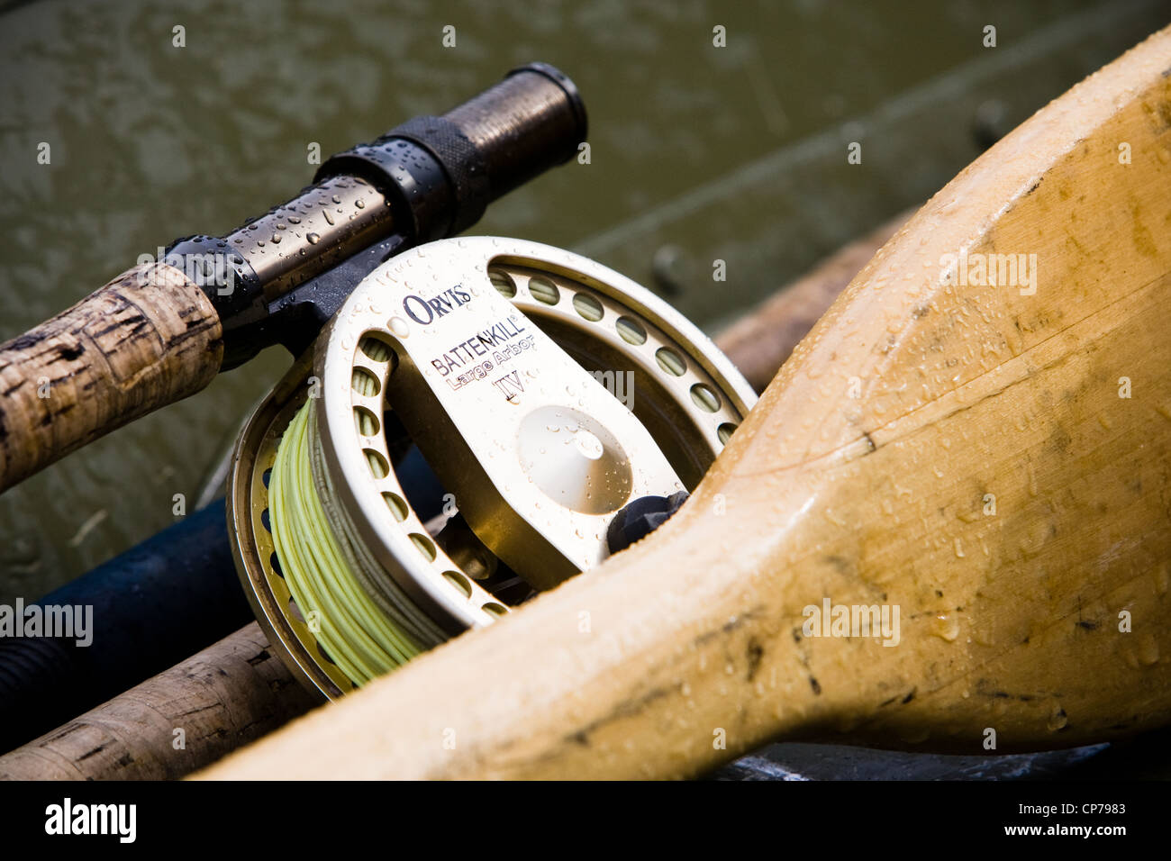 Digitally Altered, Close up of a Fly fishing reel, rod and oars laying in a skif, Southwest Alaska, Summer Stock Photo