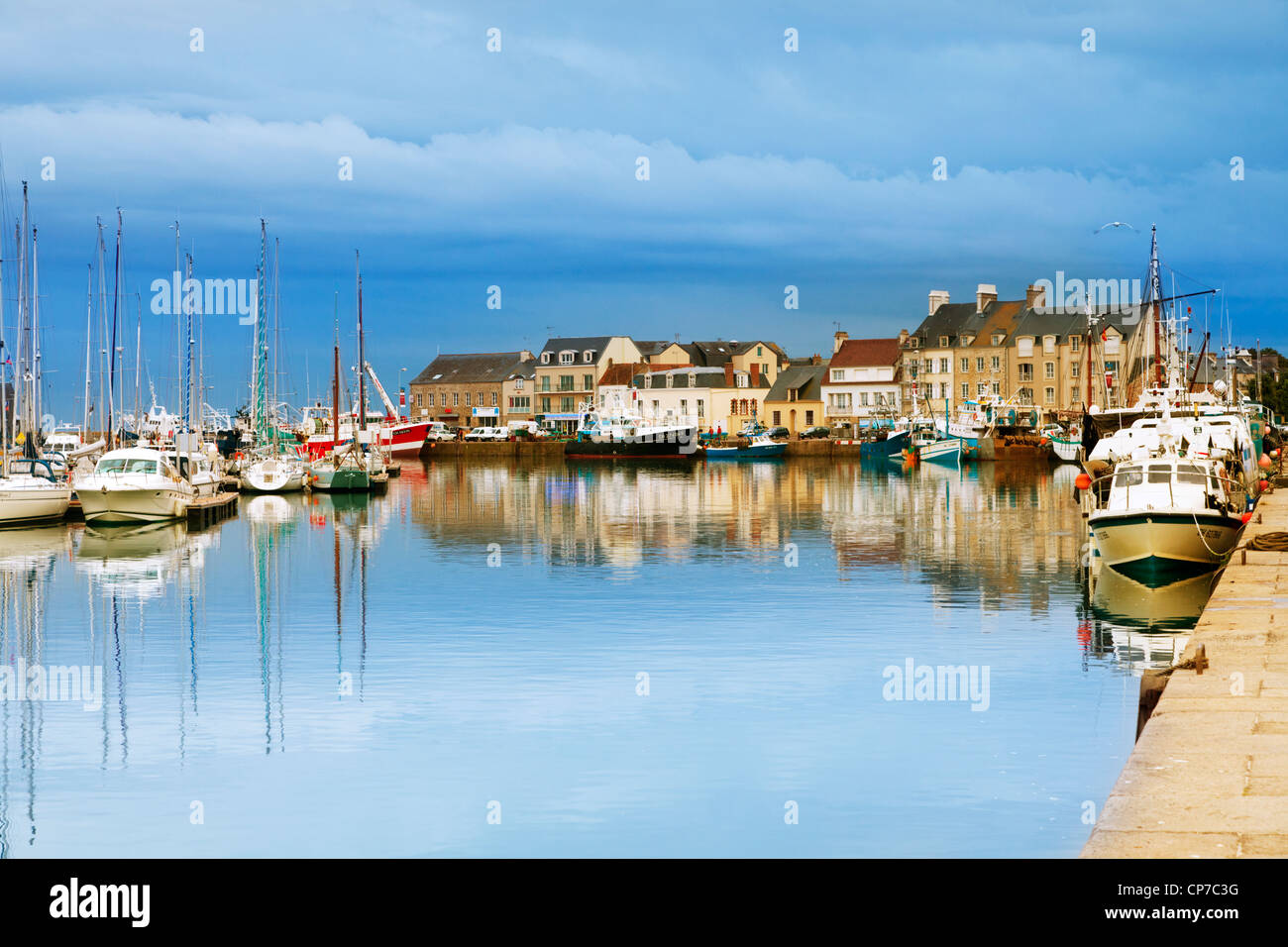 The Normandy fishing port of Saint-Vaast-La-Hougue on a calm summer evening at twilight. Stock Photo