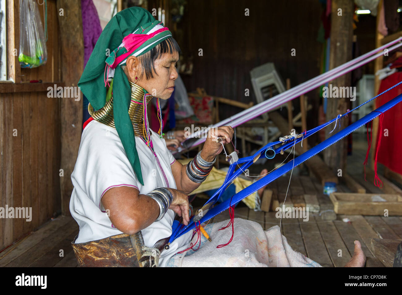 Long necked Karen woman weaving cloth, Inle Lake Myanmar Stock Photo