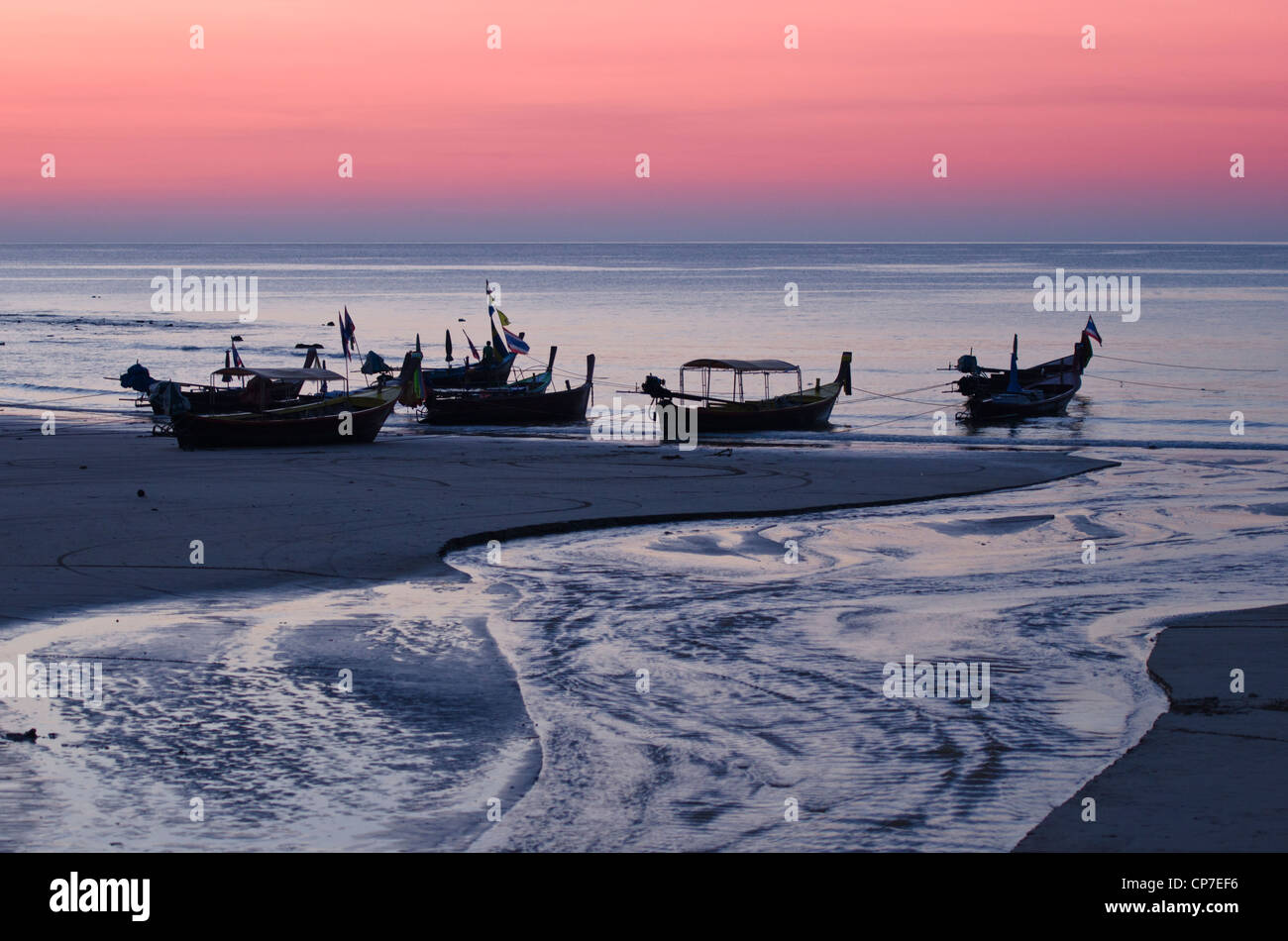 Long tail boats at sunset on Kamala Beach, Phuket Island, Thailand Stock Photo