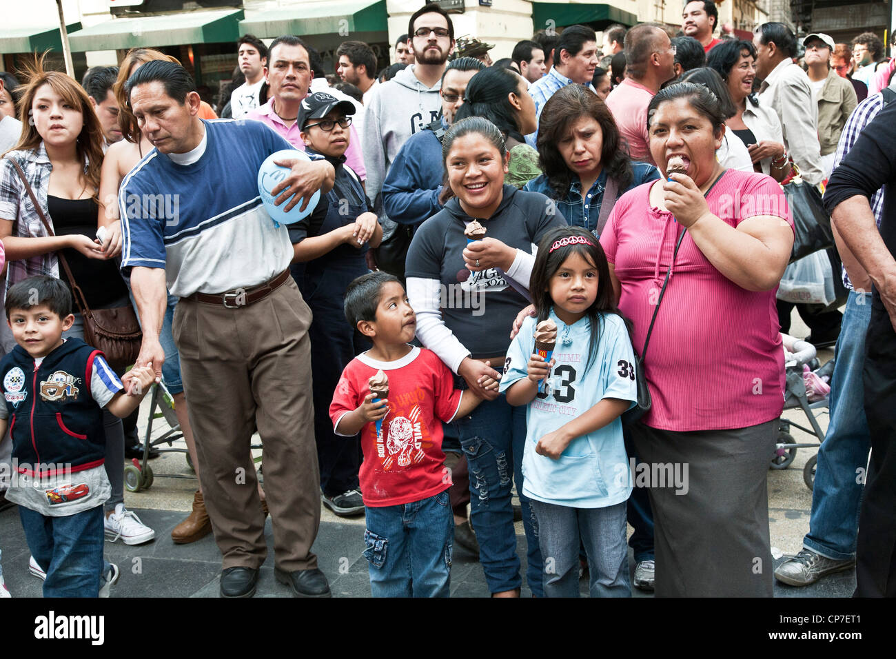 happy Mexican crowd parents children others enjoy watching street performer on pedestrian Avenida Francisco Madero Mexico City Stock Photo