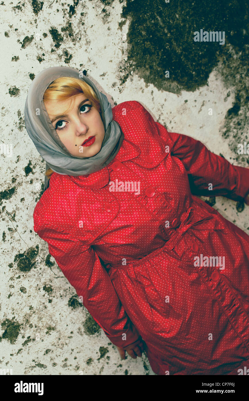 young woman with an elegant scarf and raincoat in the 60's style Stock Photo