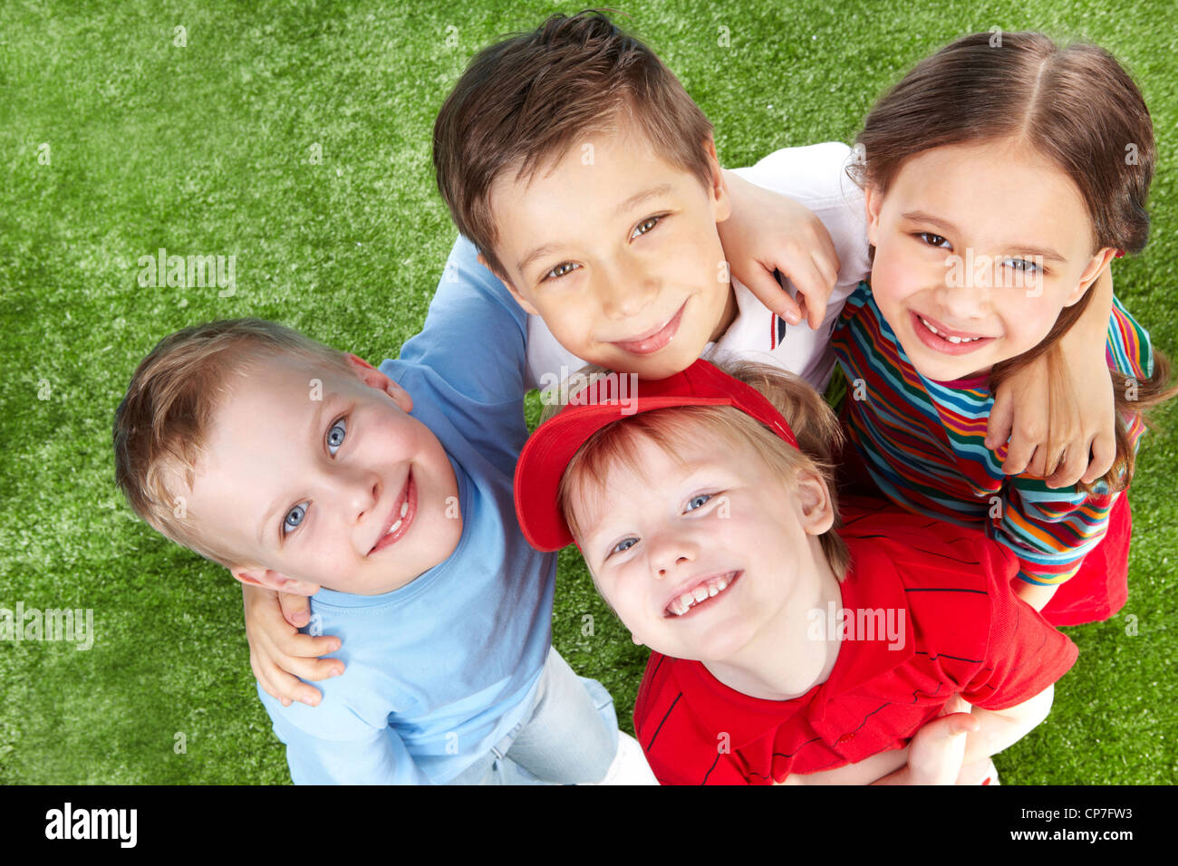 Above view of cute children hugging and smiling at cam Stock Photo - Alamy