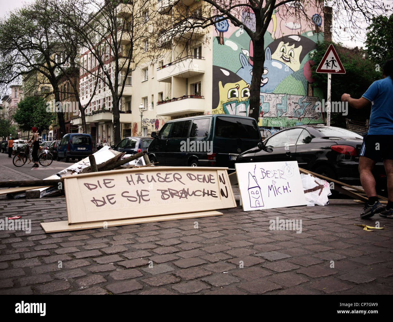 Makeshift roadblock by squatters in Berlin-Kreuzberg, Germany. The writing reads: "Houses for those who need them". 05 May 2012 Stock Photo