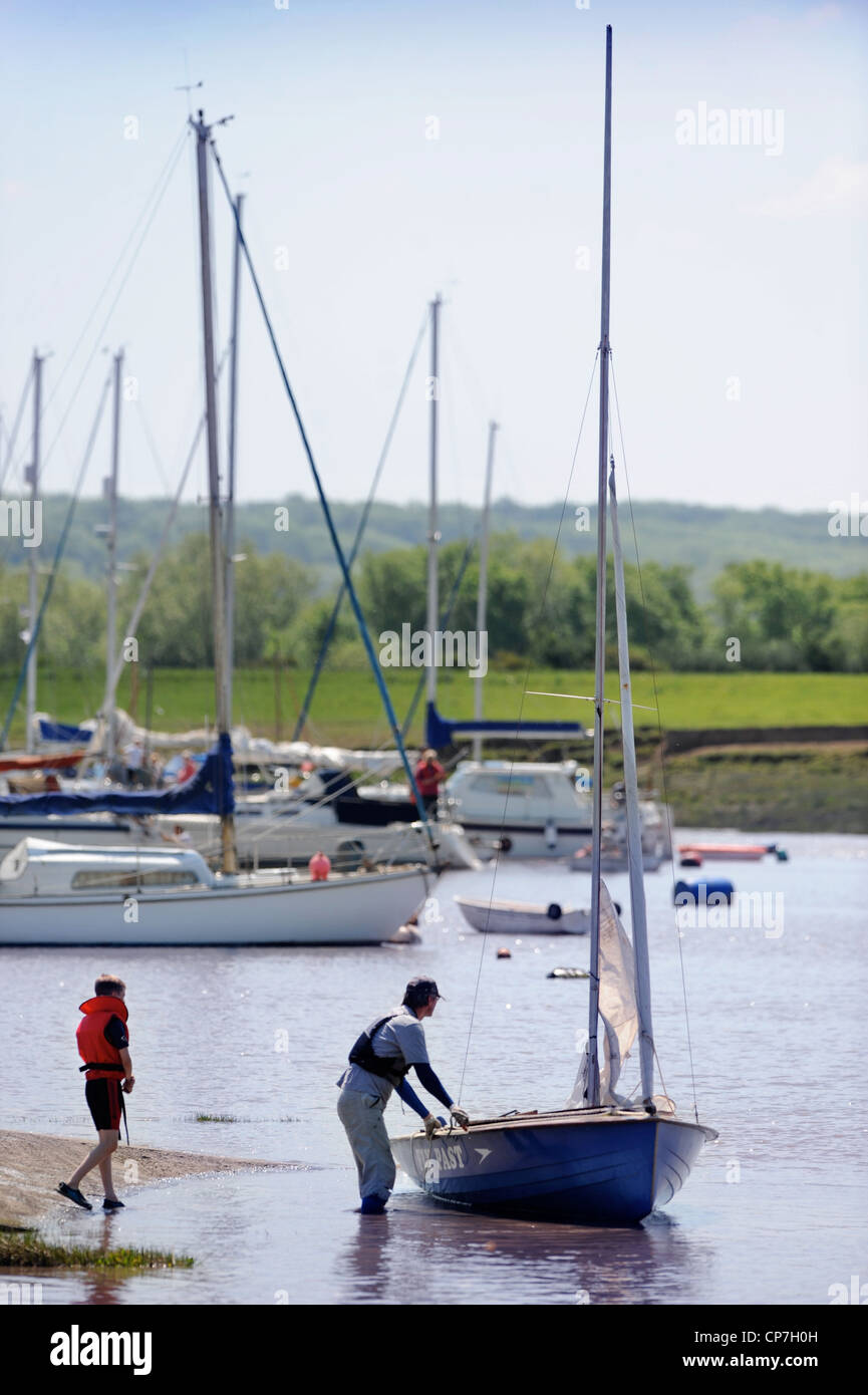 A man and boy prepare a sailing dingy at a regatta on the River Severn near Thornbury, Gloucestershire UK Stock Photo