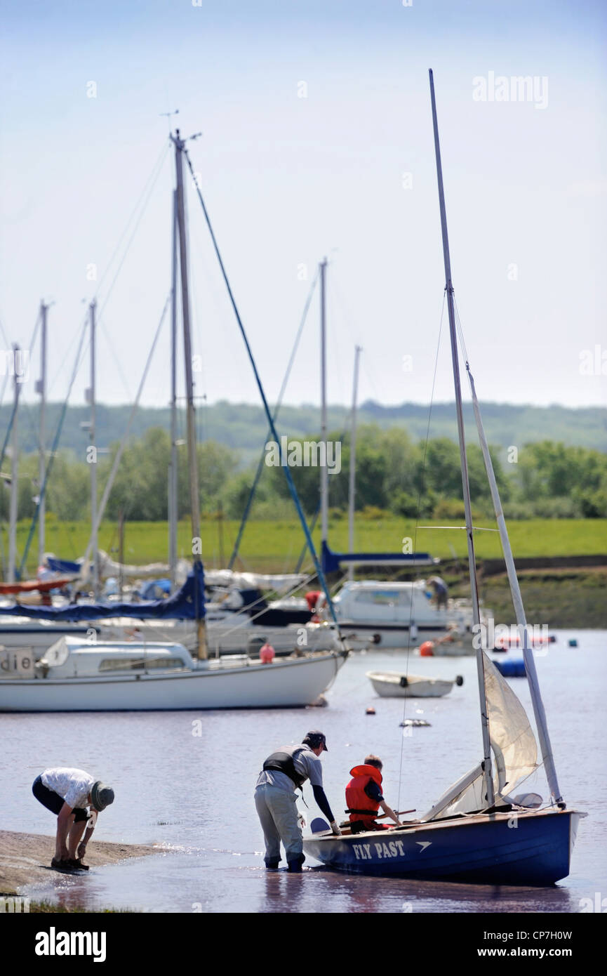A man and boy prepare a sailing dingy at a regatta on the River Severn near Thornbury, Gloucestershire UK Stock Photo
