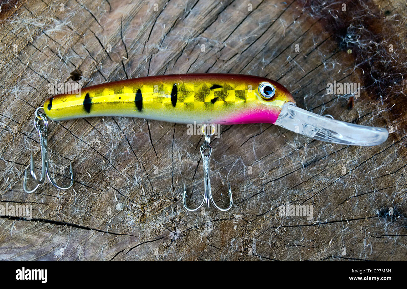 Fishing lure - Wobbler on the tree trunk background Stock Photo