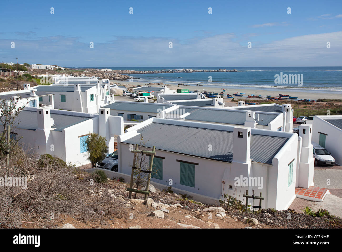 The Whitewashed Cottages Along A Long White Beach Are A