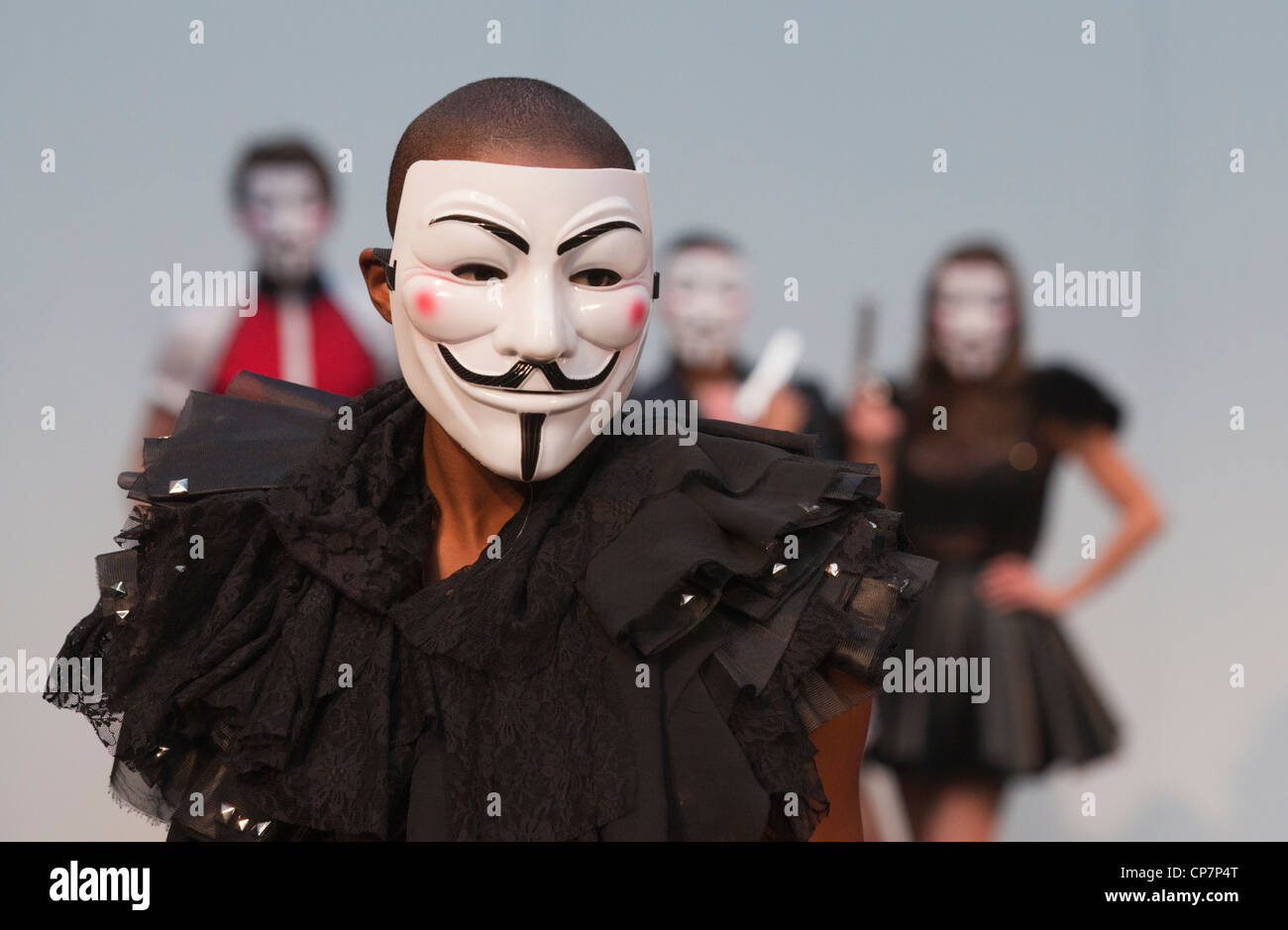 Models with 'V for Vendetta' masks modelling designs by Charlotte Haggerty and Brett Le Bratt at Alternative Fashion Week 2012 Stock Photo