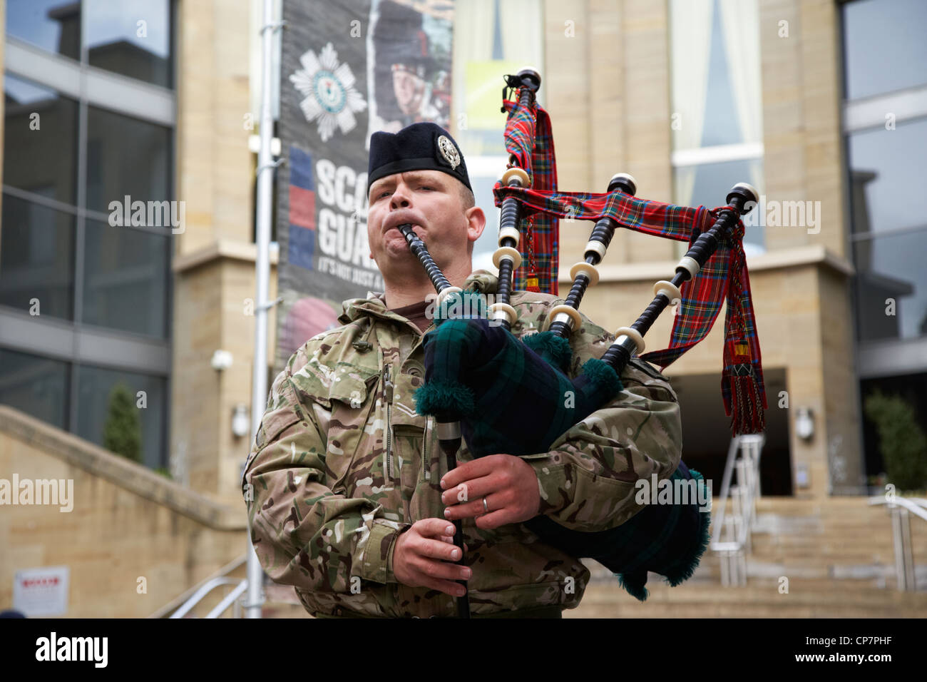 piper from the scots guards playing at an army recruiting stand in glasgow city centre Scotland UK Stock Photo