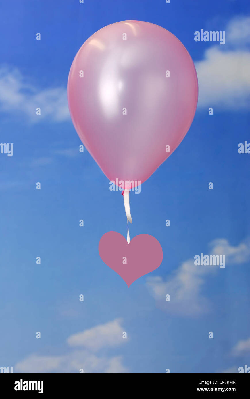 Love concept. pink heart shape hanging on a balloon in the sky with ...