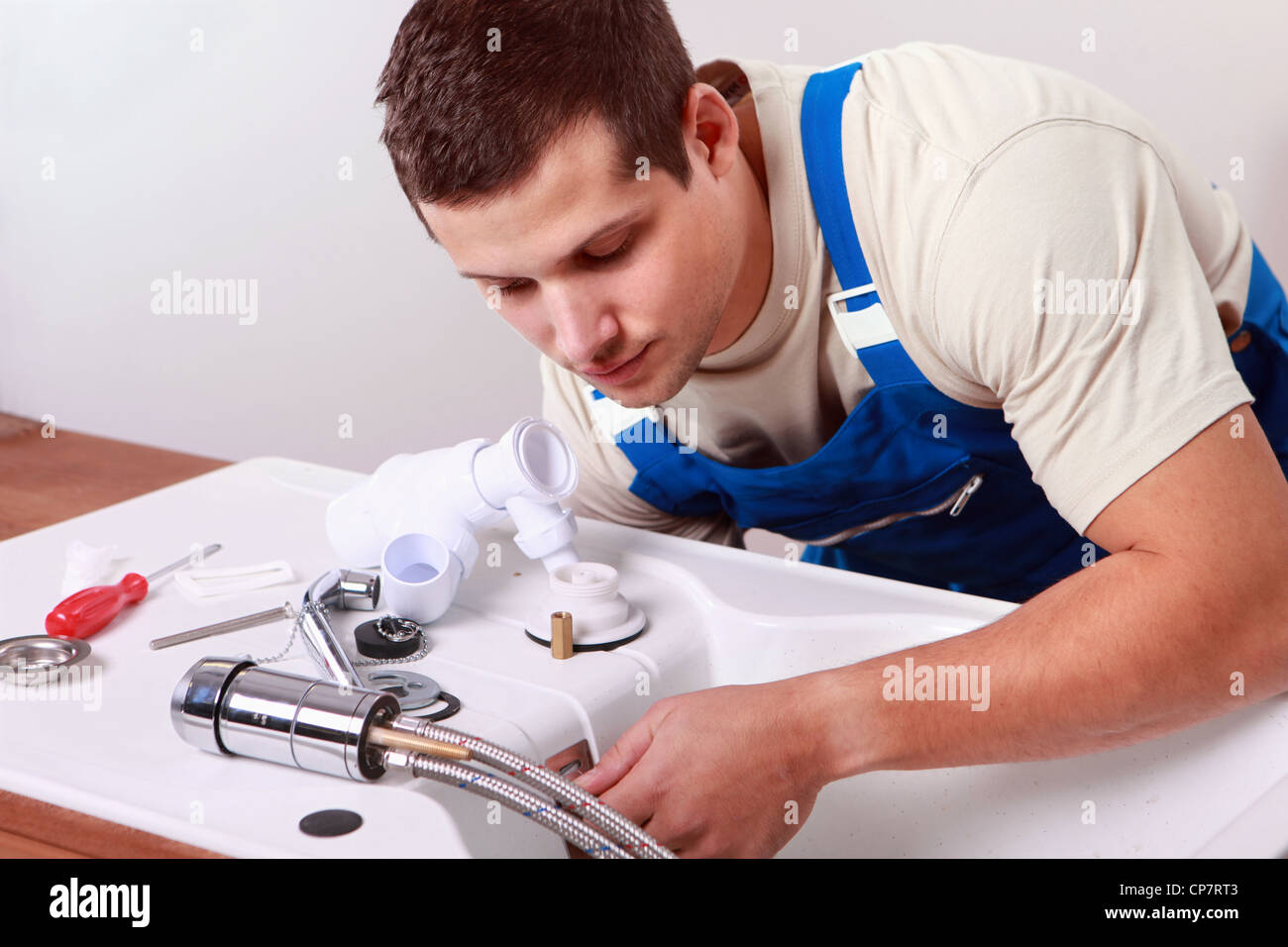 Plumbers install faucet Stock Photo Alamy