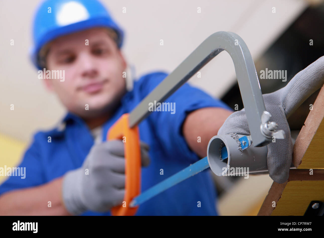 Plumbing sawing plastic pipe Stock Photo