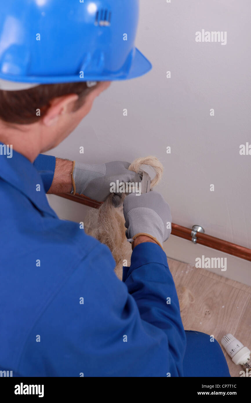 Tradesman making a loop Stock Photo - Alamy