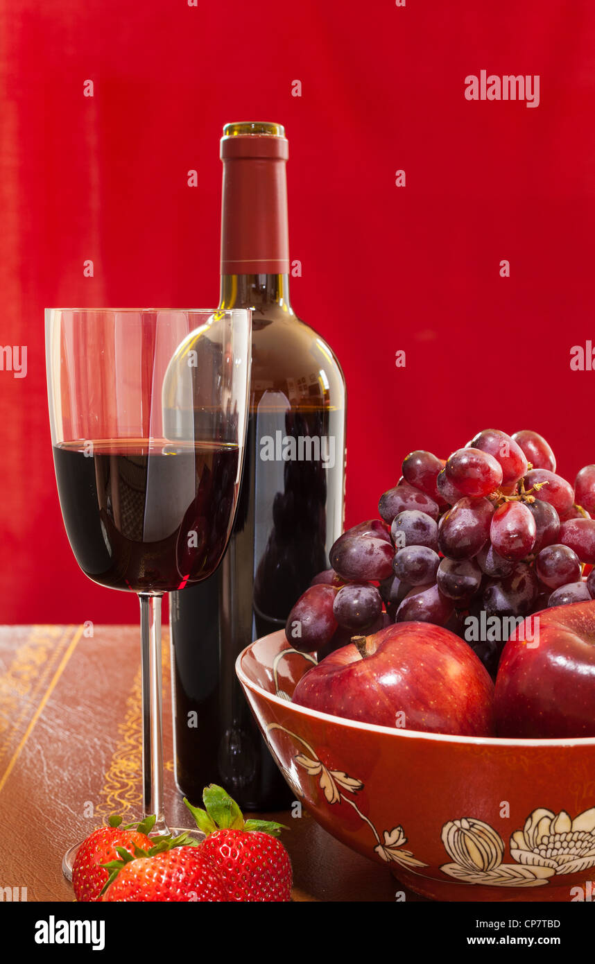 Red Wine Bottle And Red Wine In Glass With Red Apples Grapes And Strawberries Stock Photo Alamy