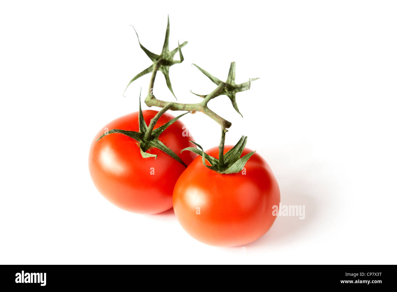 Red tomatoes with green leaves on a white background Stock Photo - Alamy