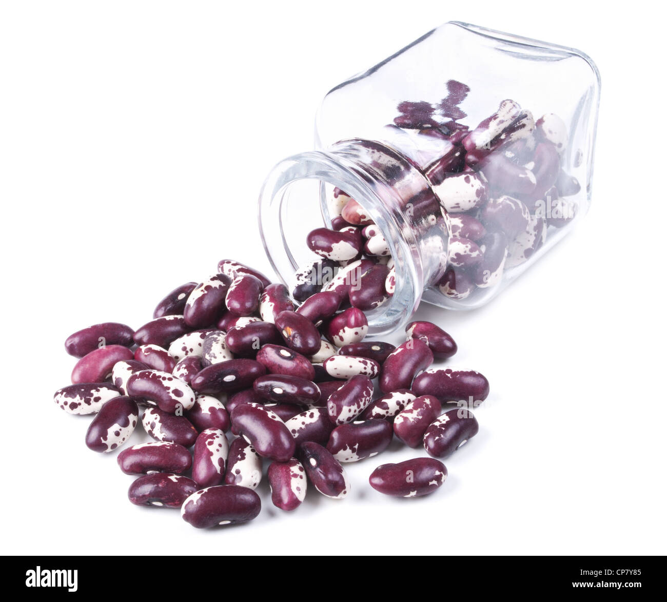 purple beans scattered on a white background from glass jar Stock Photo