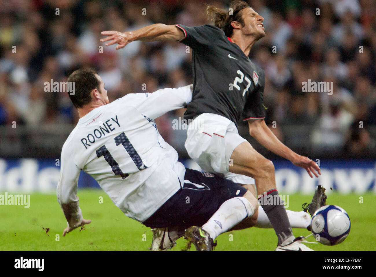 Wayne Rooney of England (L) levels a tackle on Frankie Hejduk of the USA (R) during an international soccer friendly at Wembley. Stock Photo