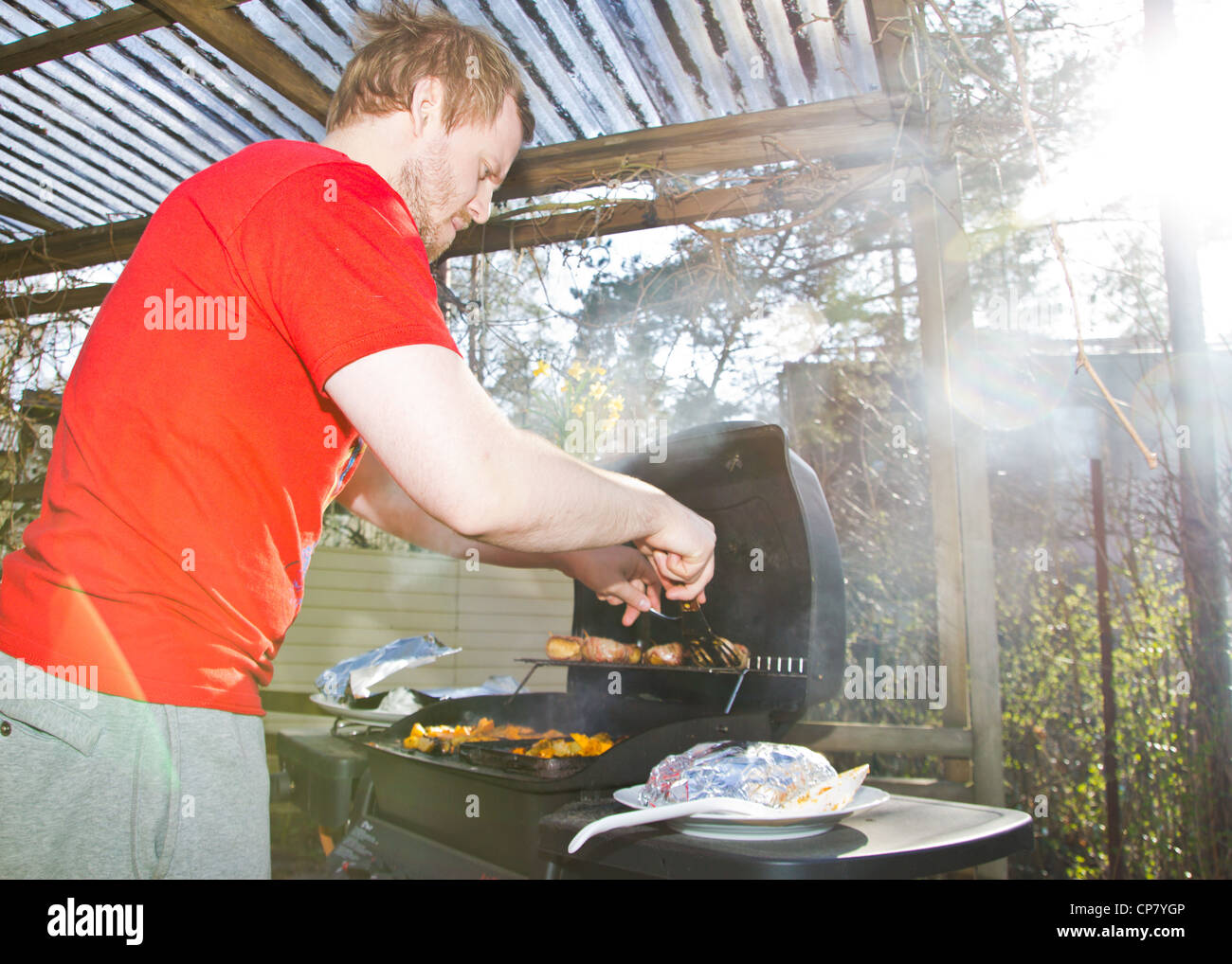 Man grilling barbeque food Stock Photo Alamy