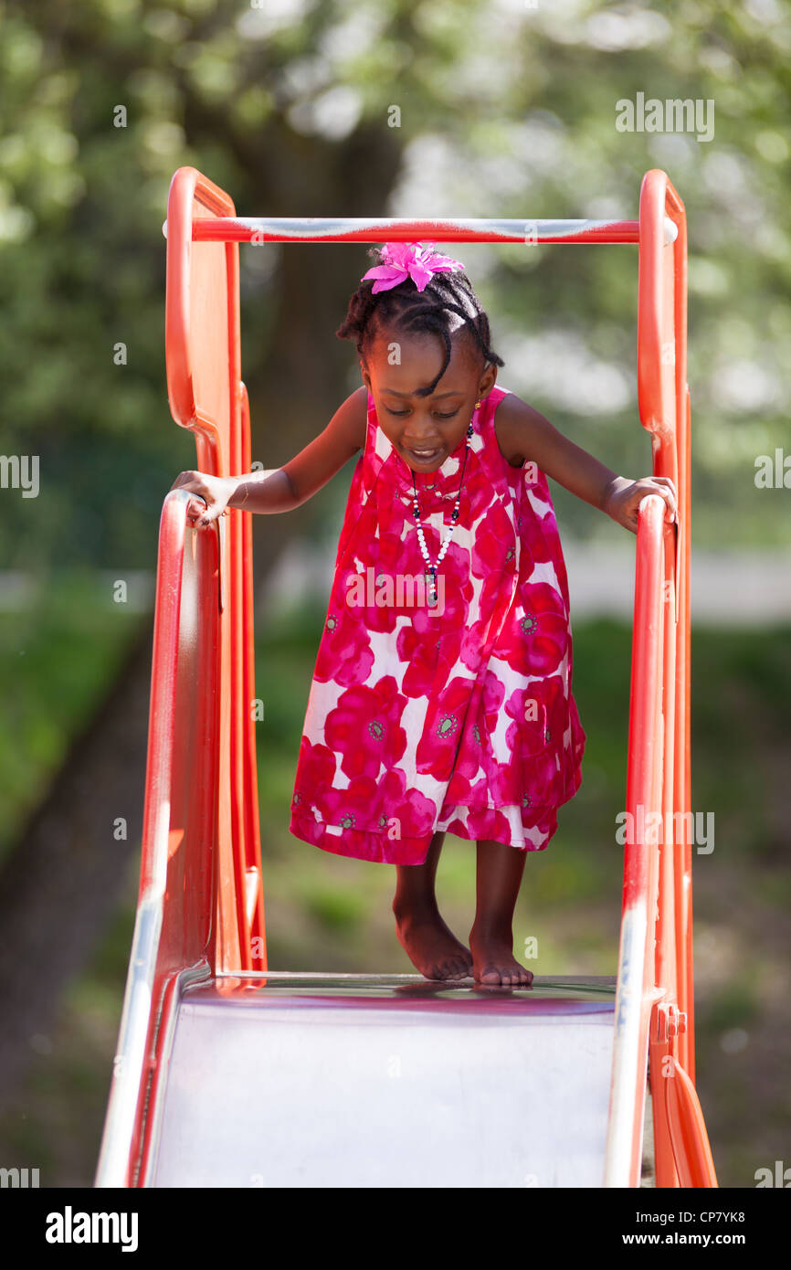 Outdoor Portrait of a cute african american little girl playing at ...
