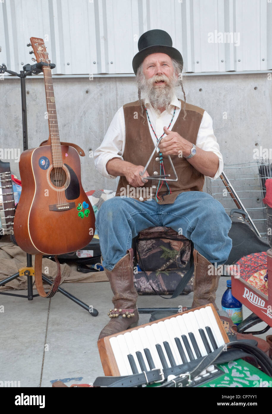 A street musician plays the triangle at the Farmer's Market in Santa Fe, New Mexico. Stock Photo