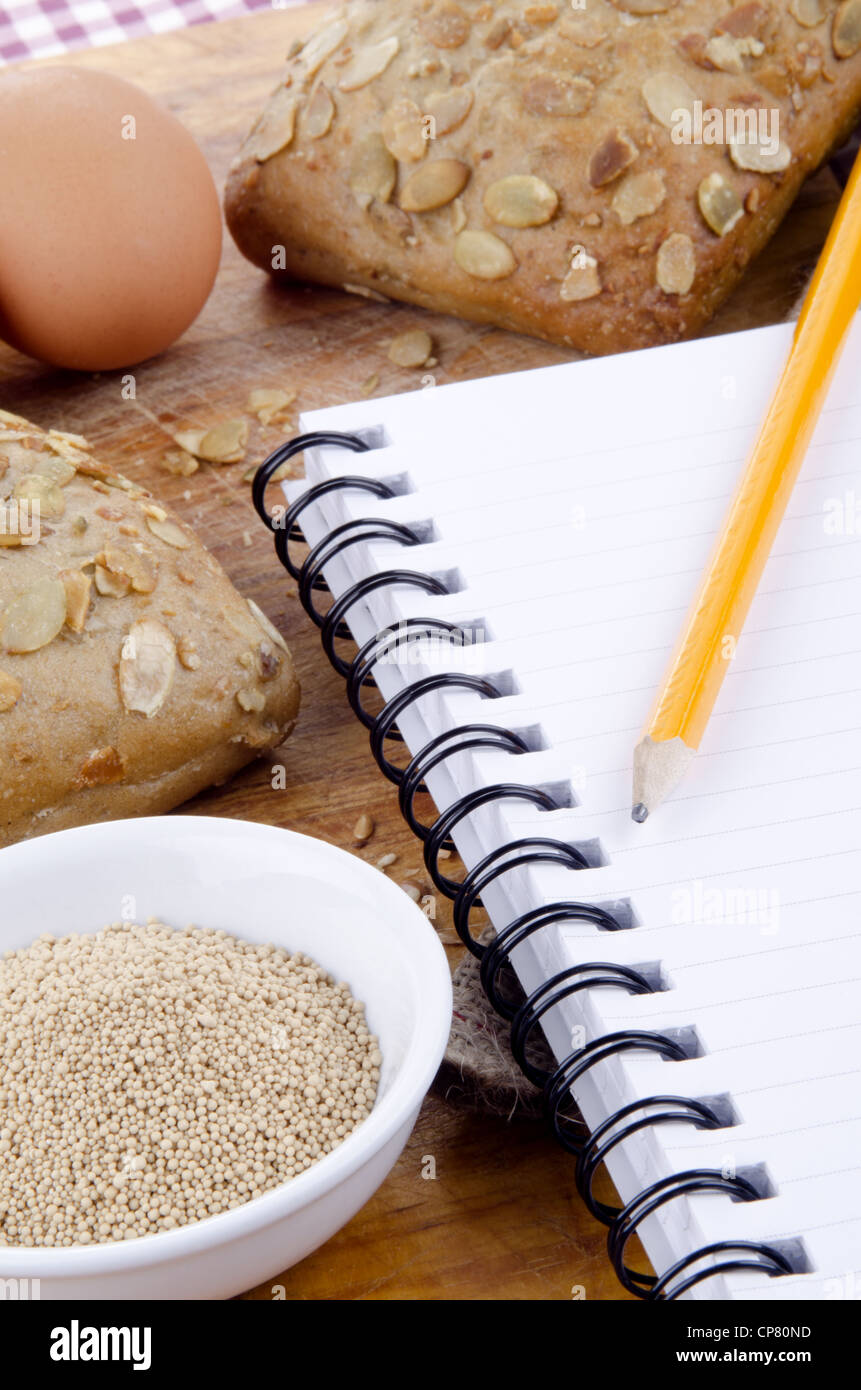 pumpkin seed roll and a booklet for notes with pencil Stock Photo