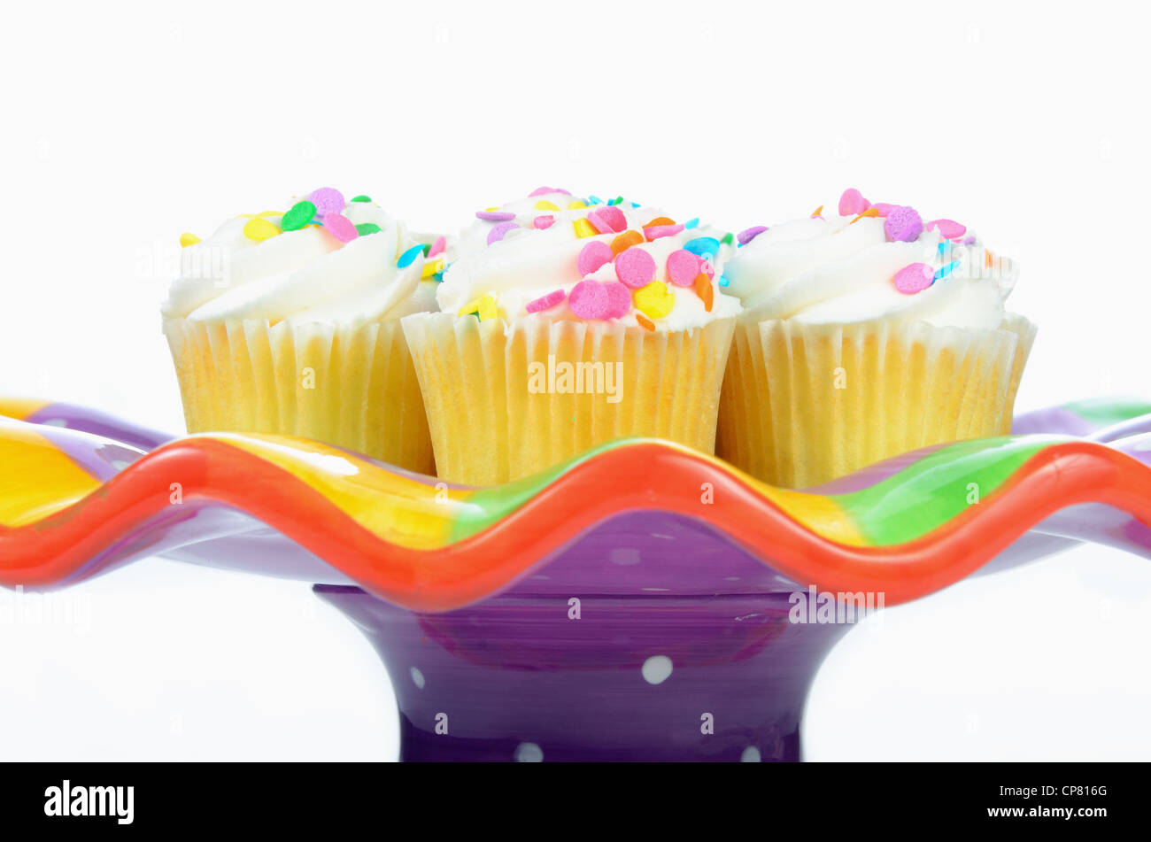 cupcakes on a colorful display plate isolated Stock Photo