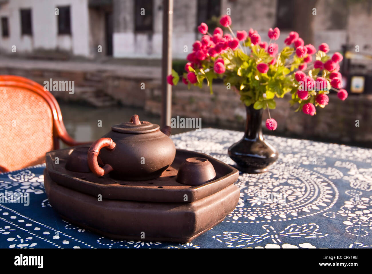 Teapot on a table from a teahouse nearby a canal in Tongli watertown near Shanghai - China Stock Photo