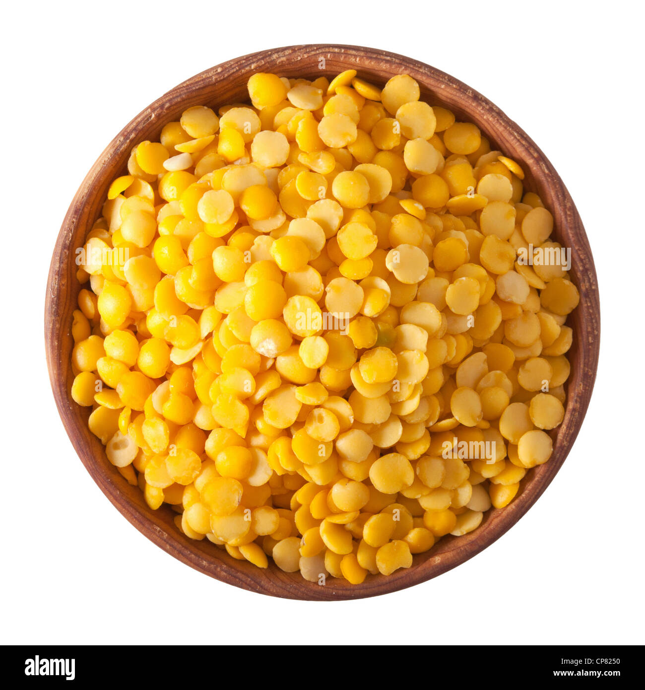 wooden bowl full of yellow split lentils isolated on white background Stock Photo