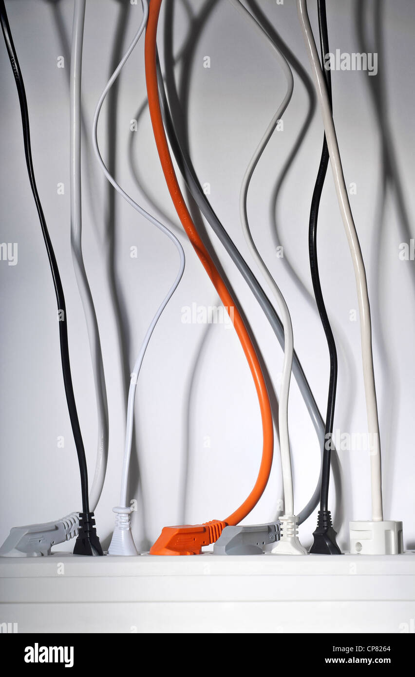 Power strip with plugs. Power cables hang down from above Stock Photo